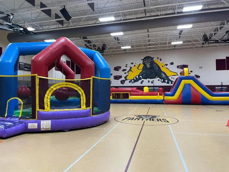 Wow Inflatables inflatable water slide rental at outdoor birthday party in Forsyth Georgia — kids sliding down large inflatable