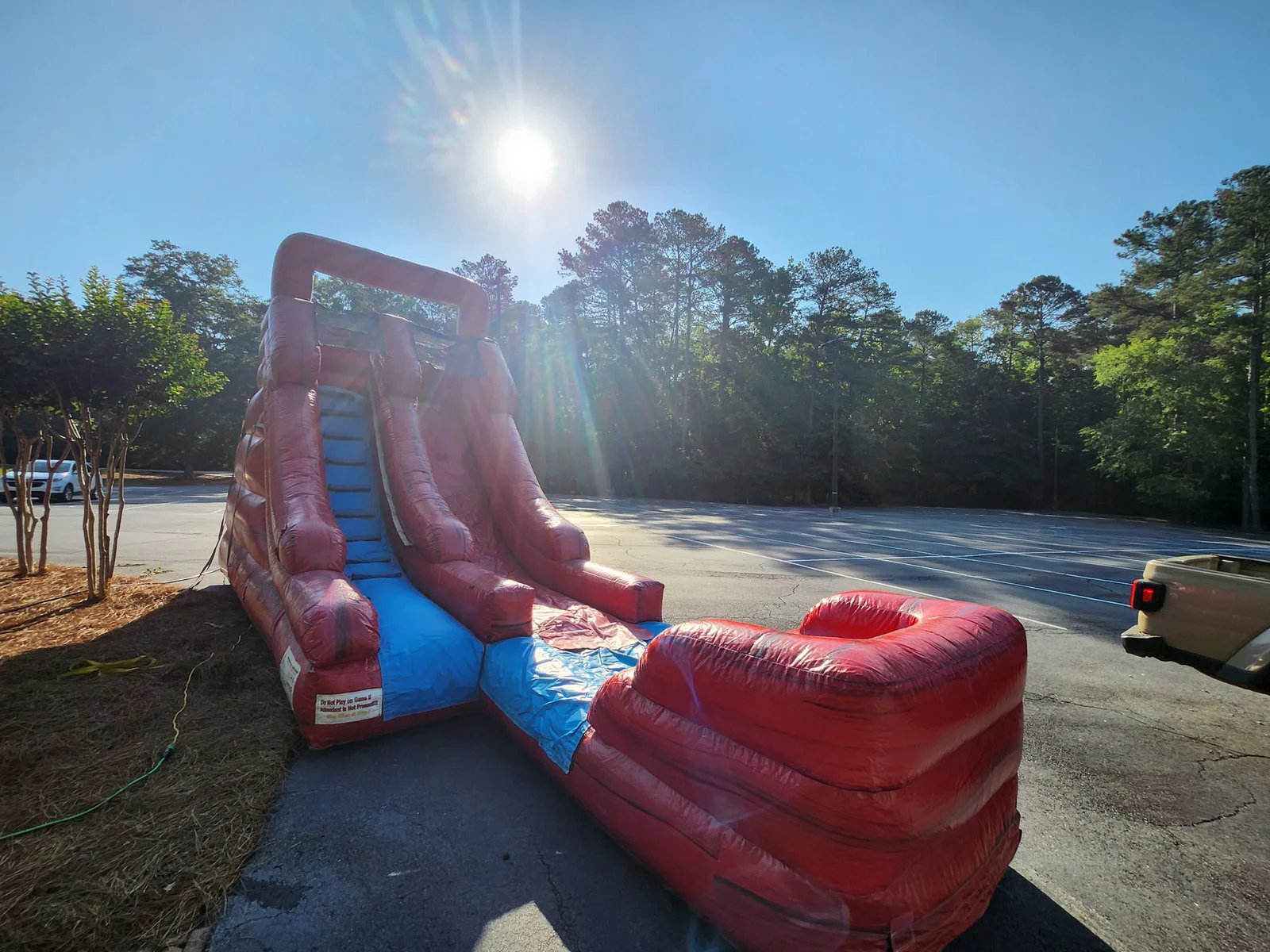 Wow Inflatables water slide rental setup at outdoor event in Middle Georgia — inflatable water slide with splash pool on green grass