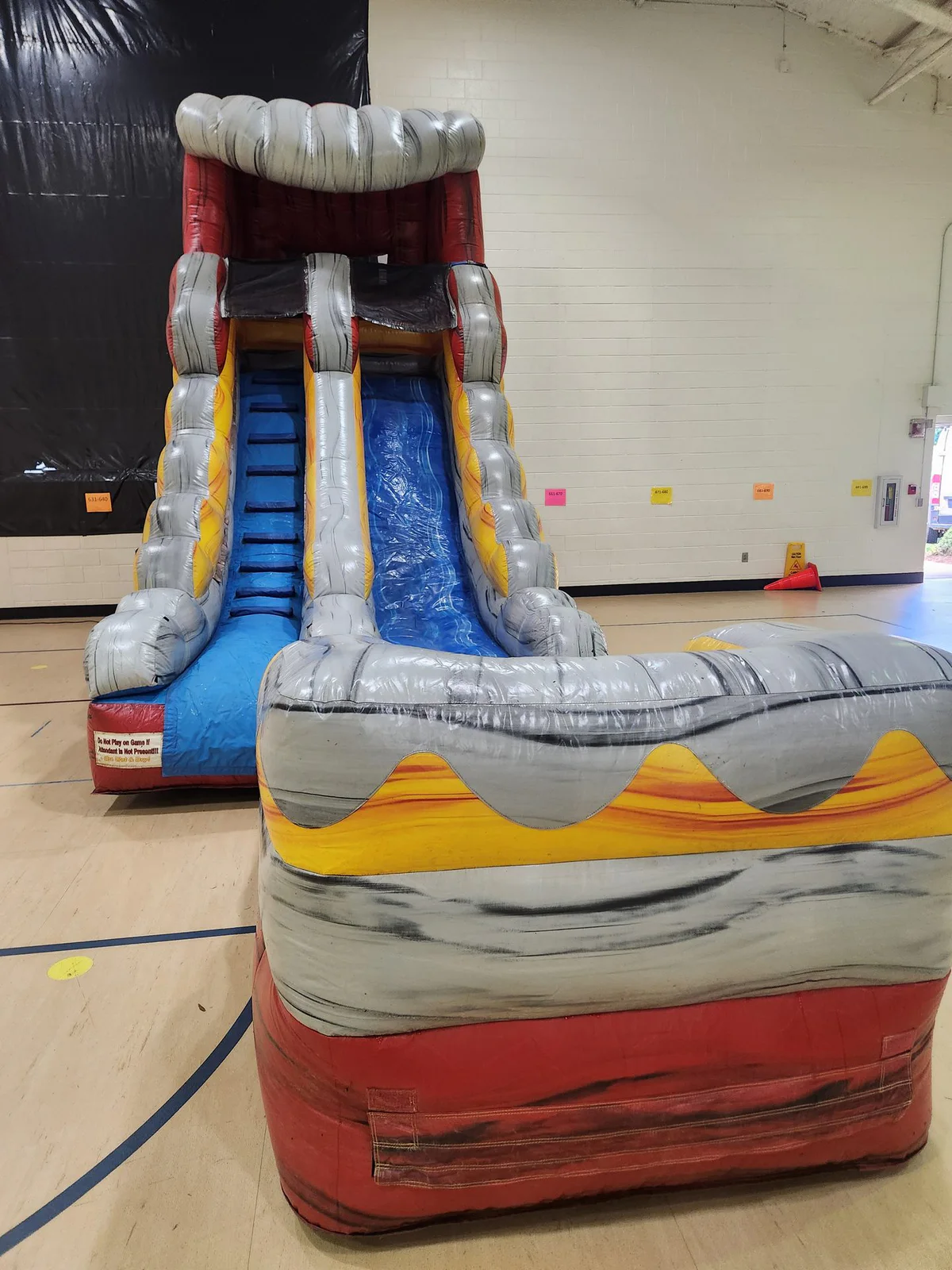 Wow Inflatables bounce house party rental at outdoor birthday celebration in Middle Georgia — colorful inflatable bounce house on green grass