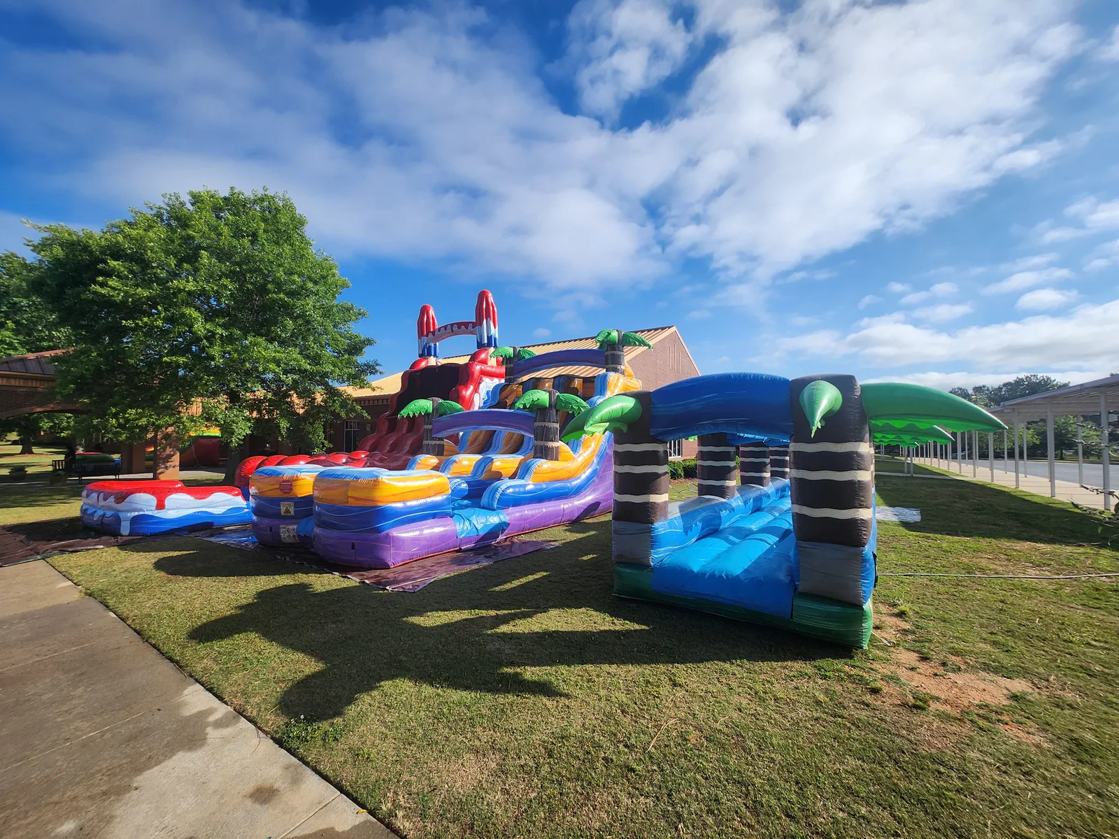 Wow Inflatables inflatable rental setup at outdoor party event in Middle Georgia — bounce house and slide at summer celebration