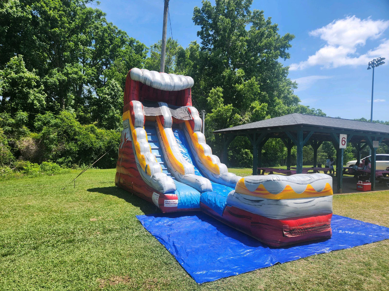 Wow Inflatables combo bounce house and water slide rental at outdoor event in Middle Georgia — inflatable combo unit with bounce area and water slide
