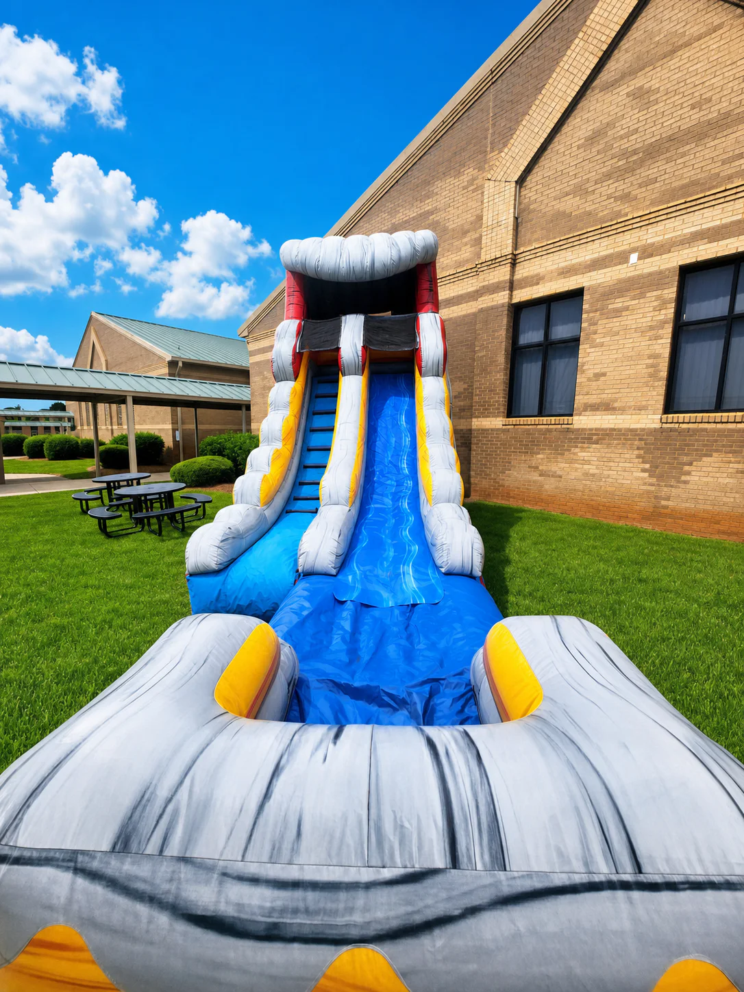 Wow Inflatables tall grey inflatable water slide rental front view at outdoor summer birthday party in Middle Georgia
