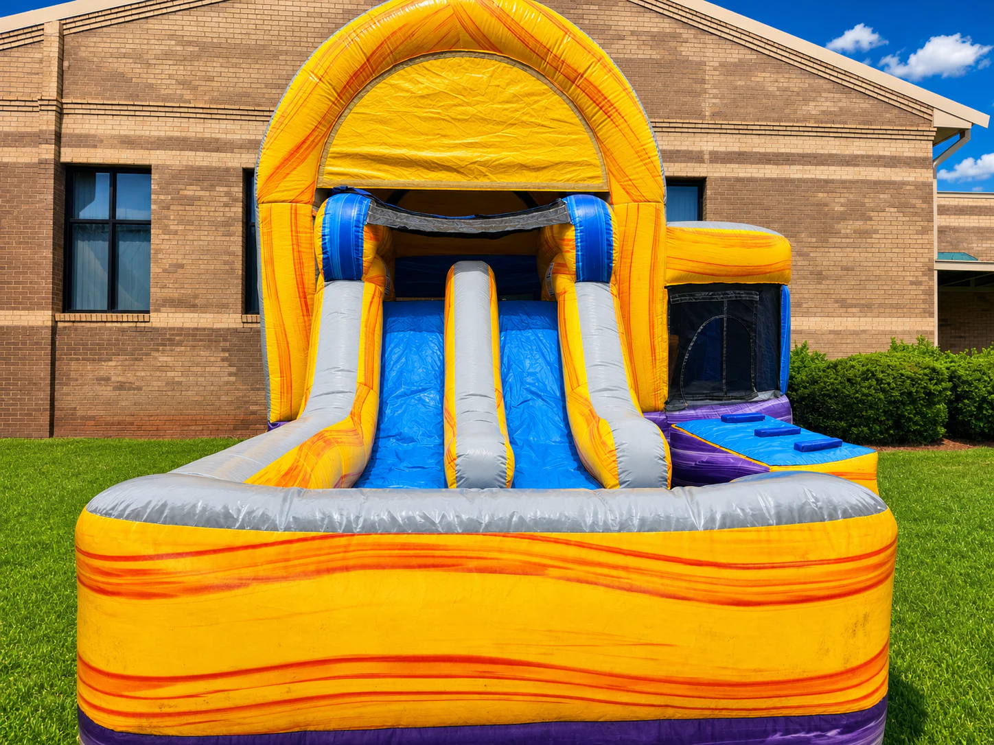 Wow Inflatables yellow and purple combo bounce house water slide rental close-up front view at outdoor event in Georgia