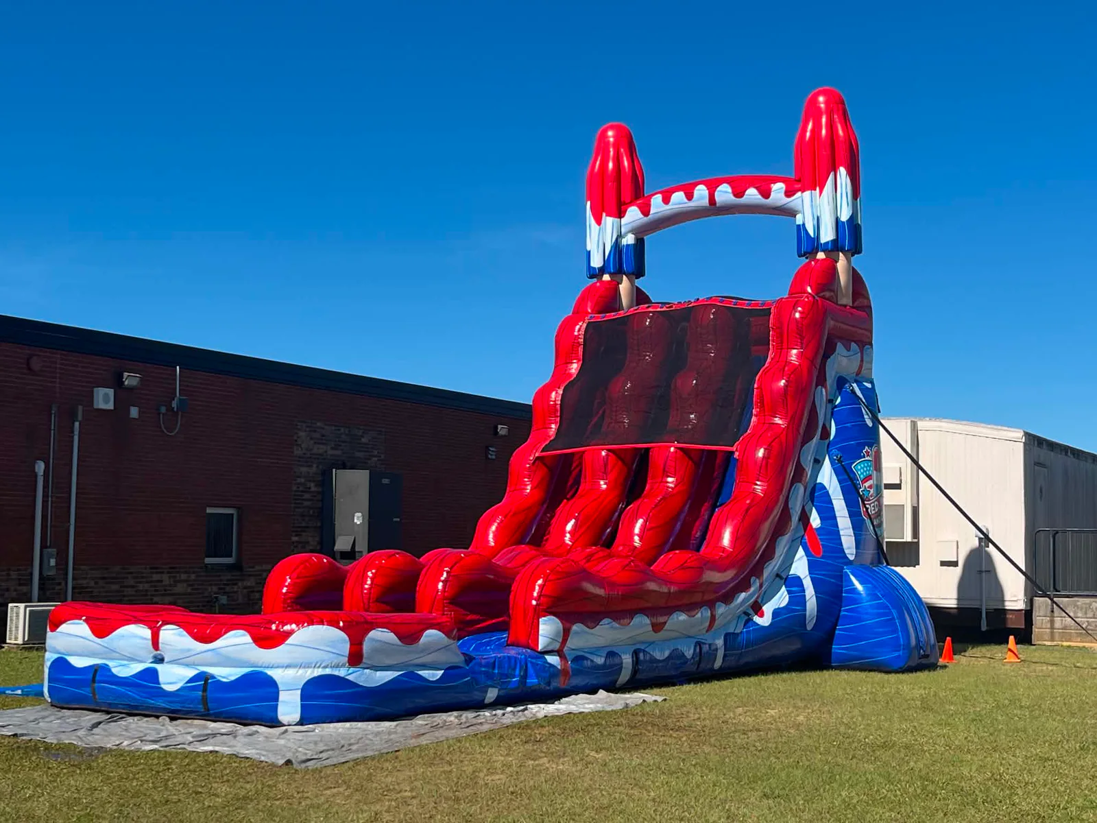 Wow Inflatables red white and blue patriotic popsicle water slide with splash pool rental at outdoor event in Warner Robins Georgia