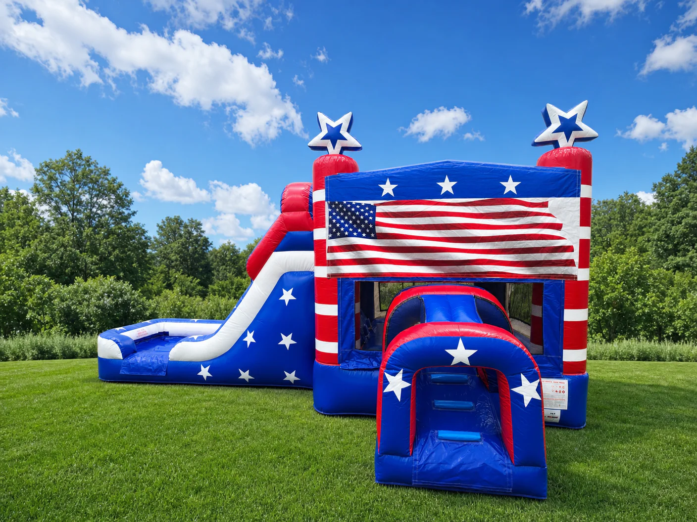 Wow Inflatables patriotic American flag combo bounce house rental front view with red white and blue colors white stars and entrance tunnel on green grass in Warner Robins Georgia — patriotic inflatable rental Houston County