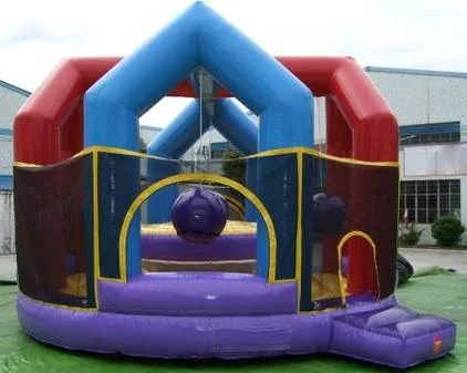 Wow Inflatables wrecking ball inflatable game rental at outdoor party in Middle Georgia — red blue and purple interactive inflatable challenge game