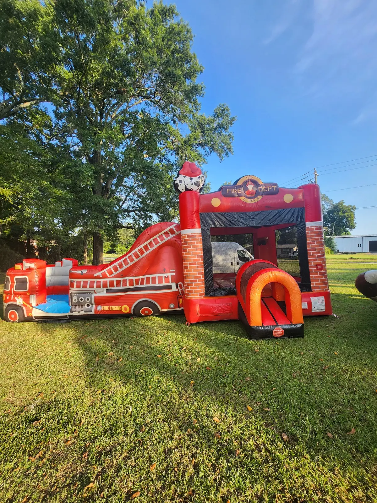Owner-supplied photo of a red fire truck inflatable combo with bounce house, climbing area, and slide for Middle Georgia rentals