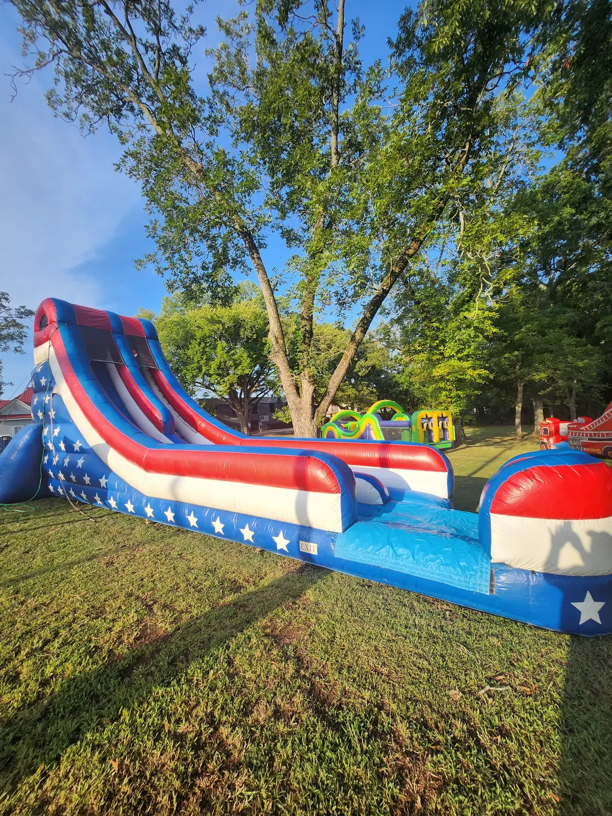 Owner-supplied photo of a red white and blue patriotic inflatable water slide for Middle Georgia summer rentals