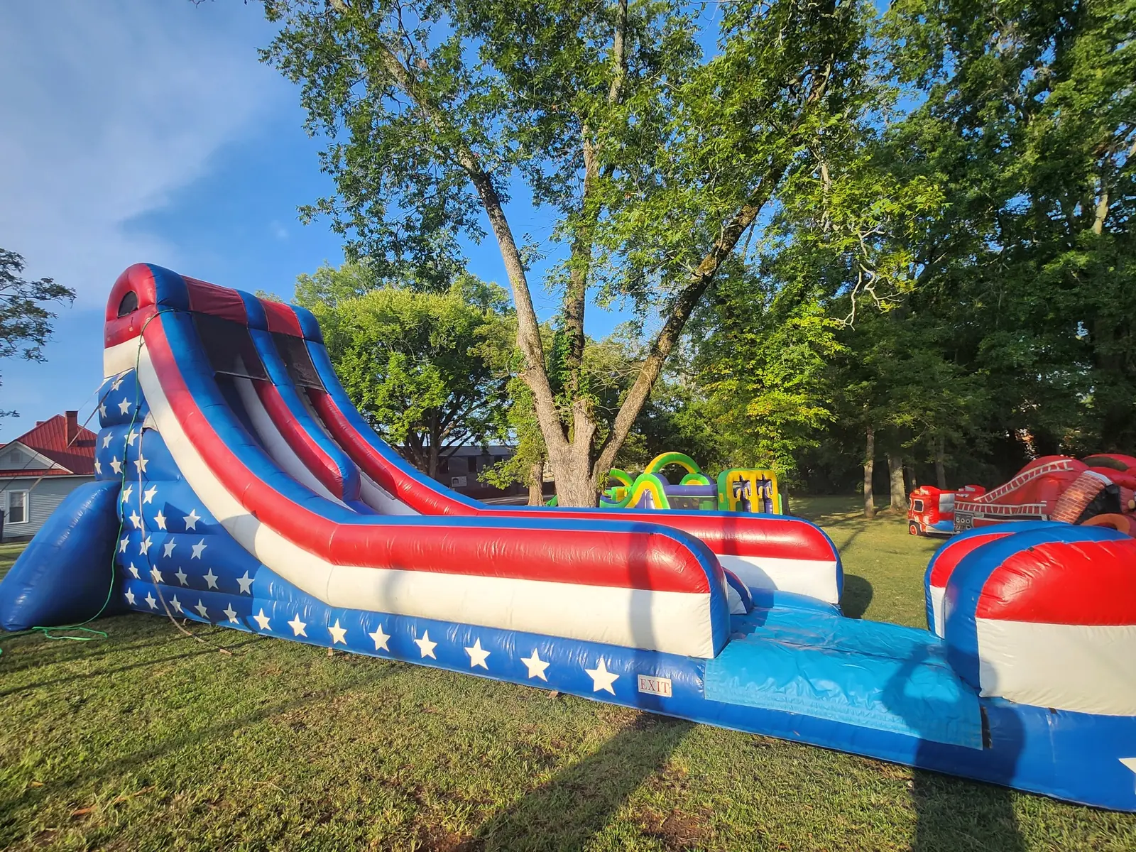 Owner-supplied side view of a patriotic red white and blue inflatable water slide for Middle Georgia rentals