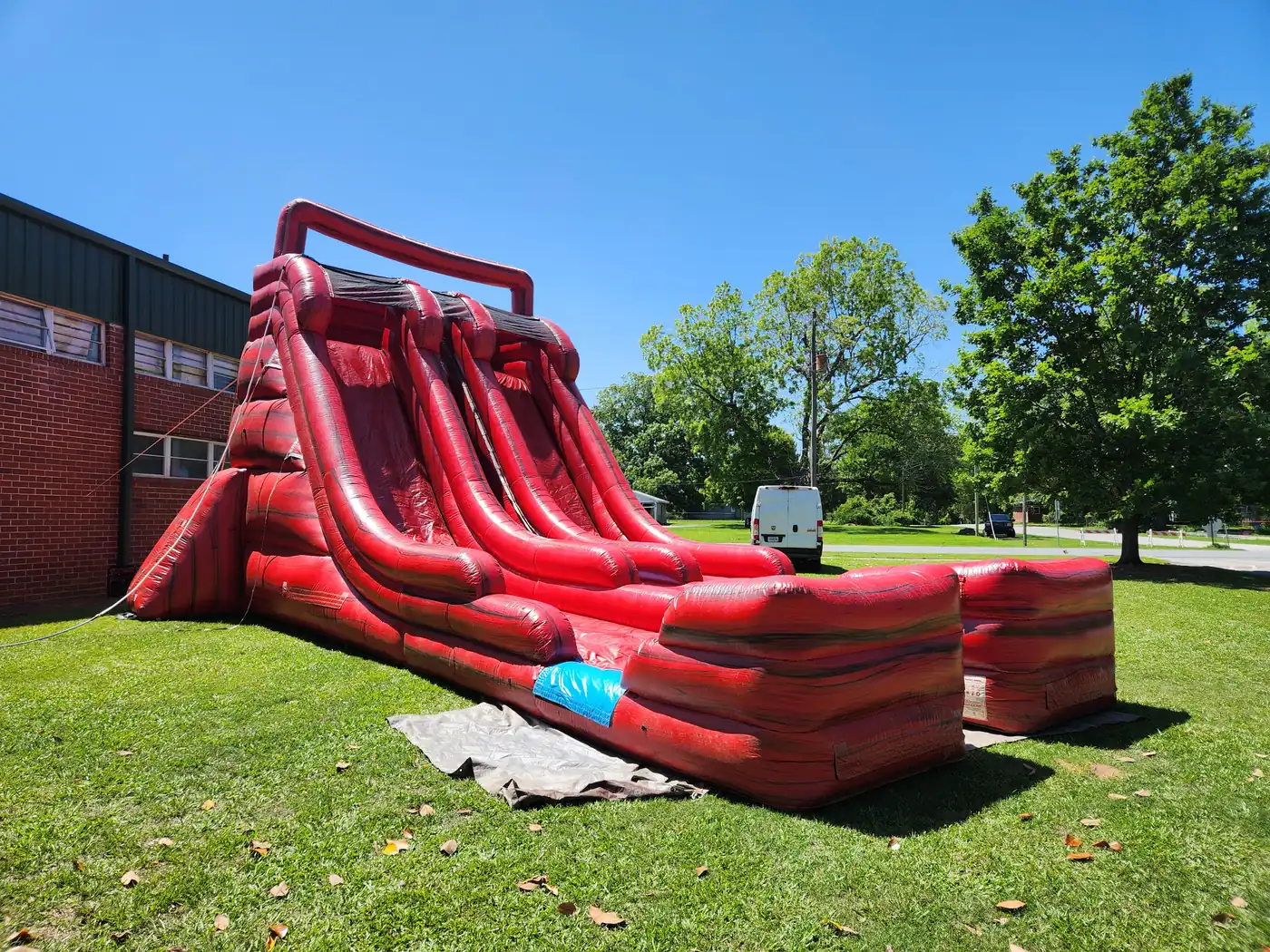 Red Rush dual-lane water slide set up dry on the lawn at St. George's Episcopal School in Milner, GA